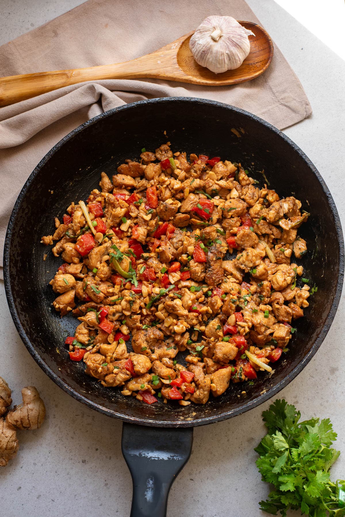 Chicken stir fry in a black pan.