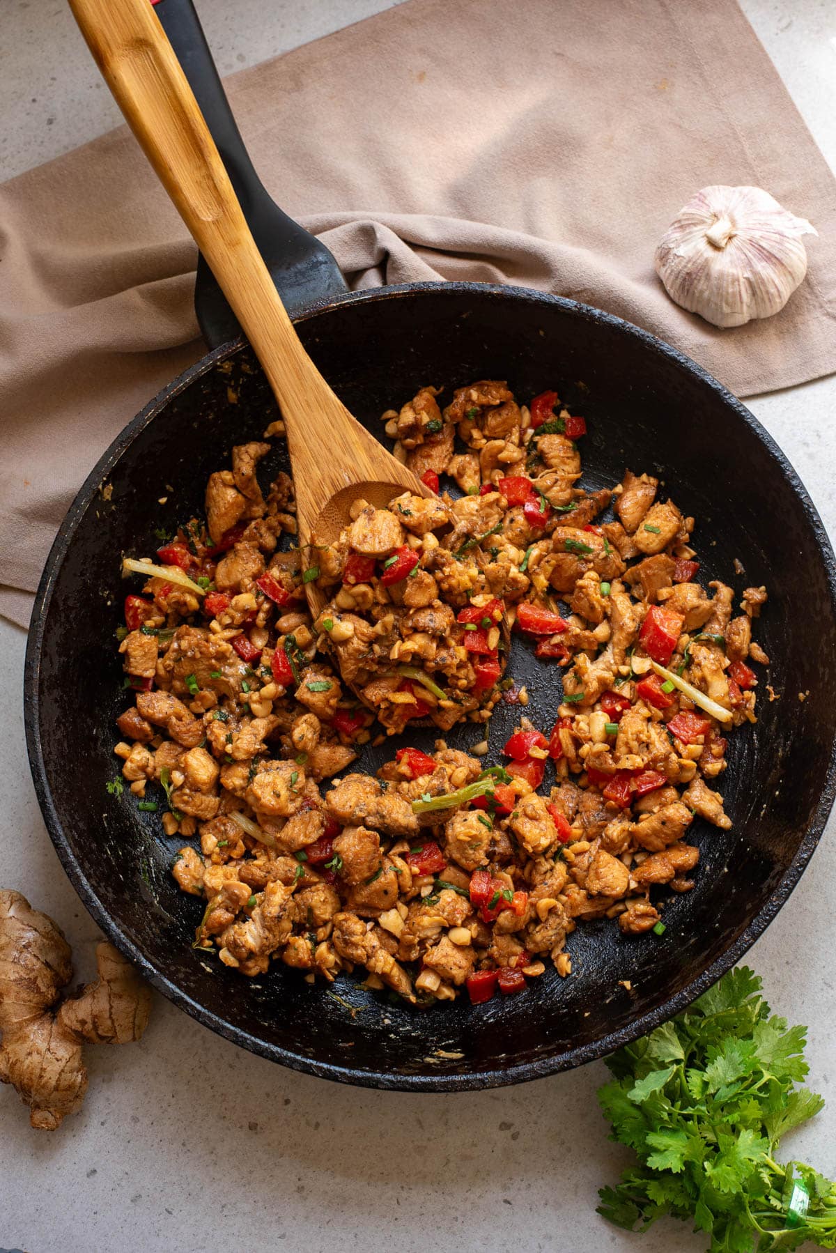 Chicken stir fry in a black pan.