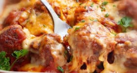 Meatball casserole topped with cheese.