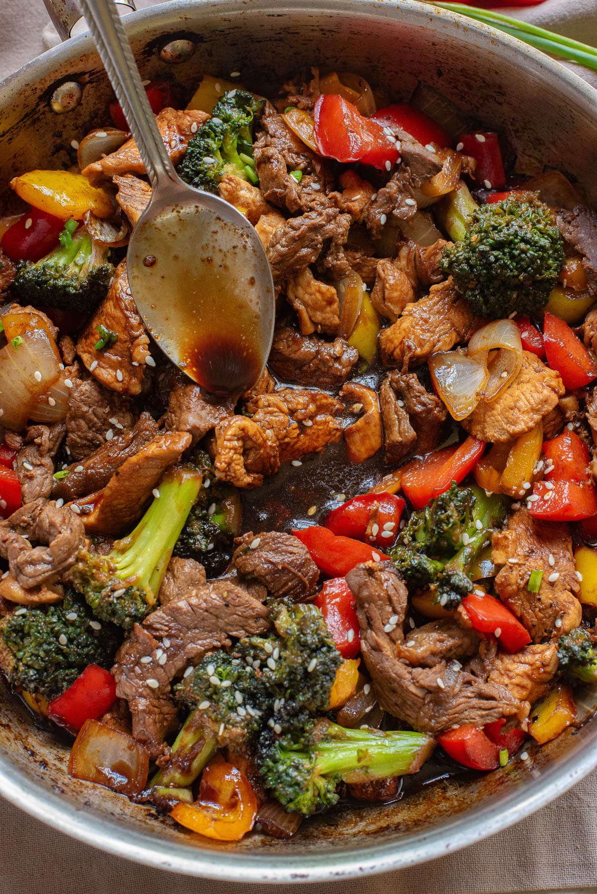 Chicken and steak with vegetables in a stir fry sauce.