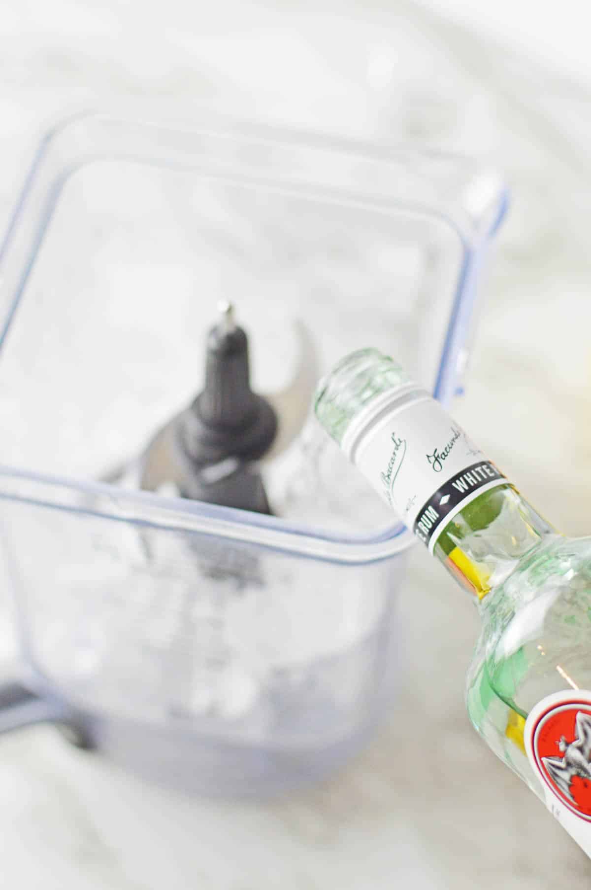 Adding rum to blender.