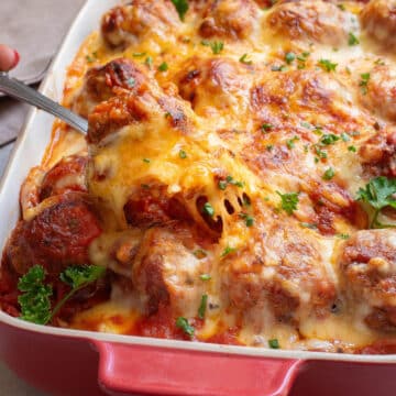 Meatball casserole topped with cheese.