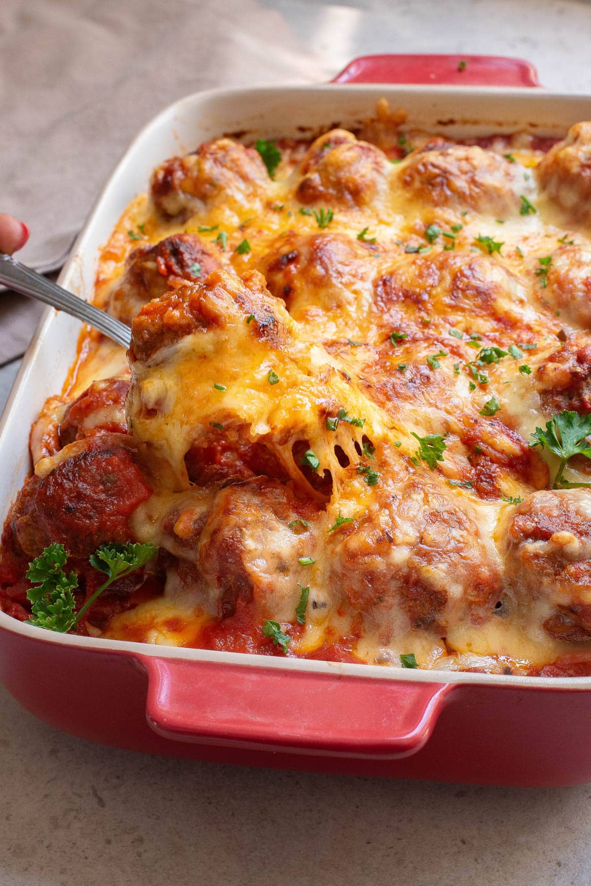 Meatballs in marinara and cheese baked in a casserole dish.