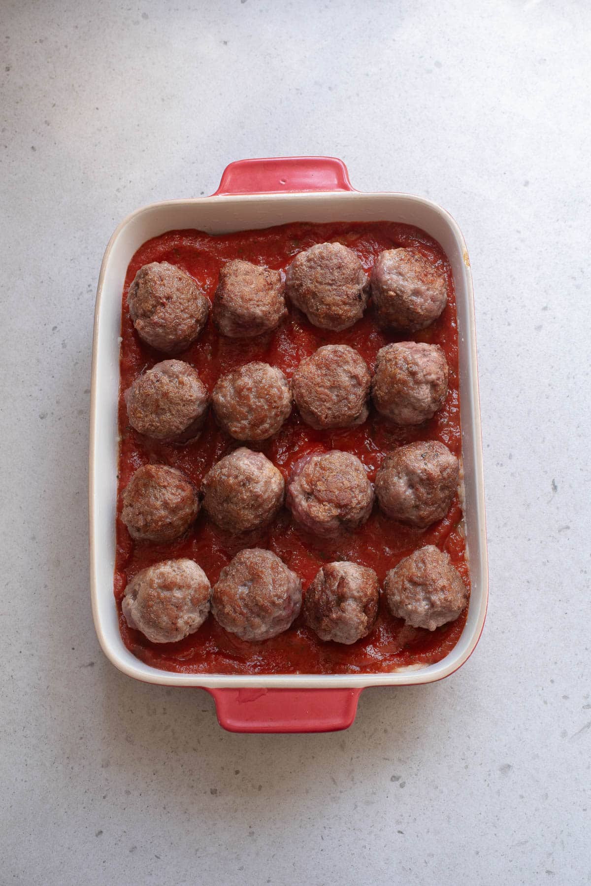 Meatballs over potatoes and marinara.