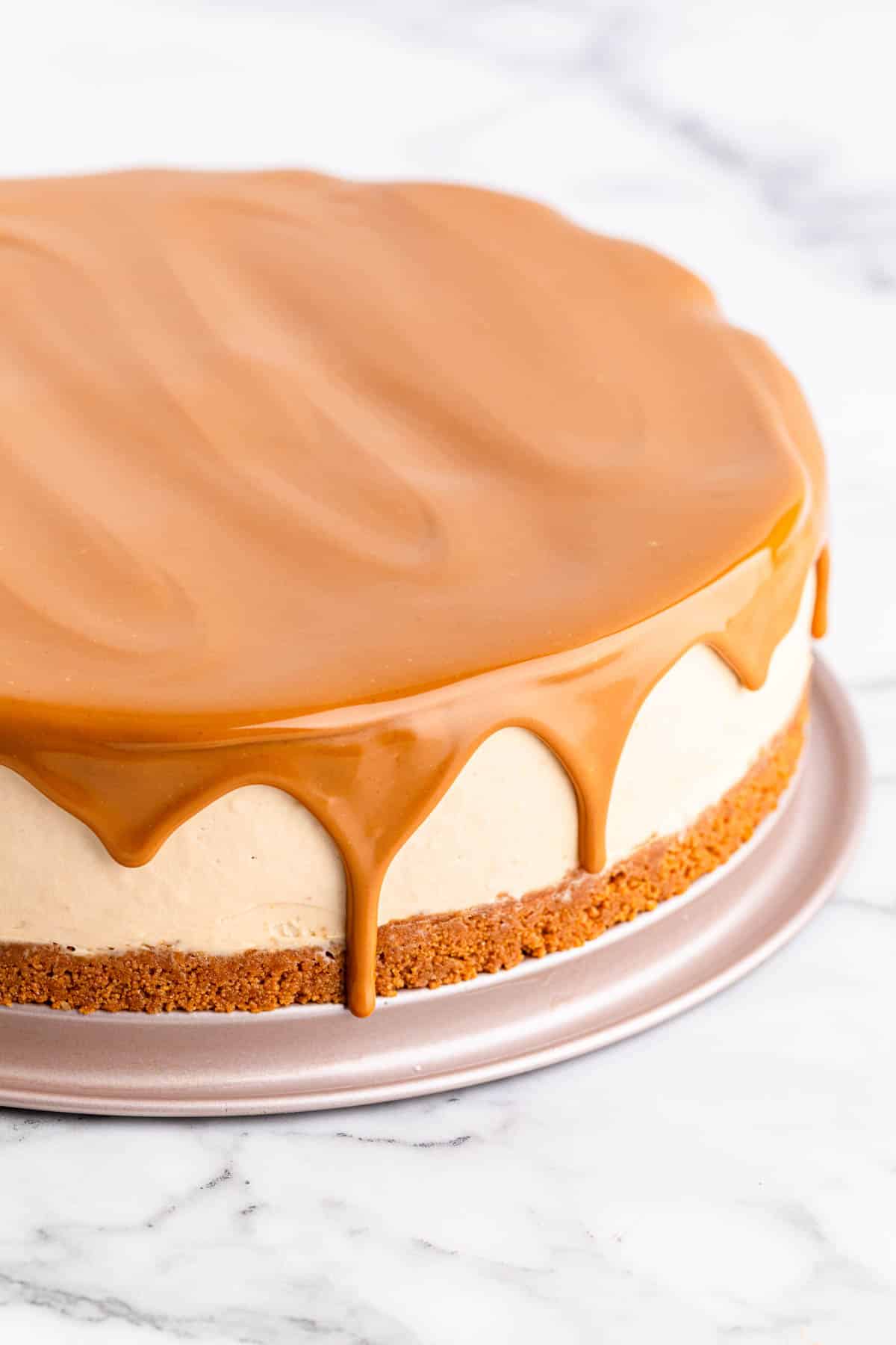 Biscoff cheesecake with topping drizzling down the side.