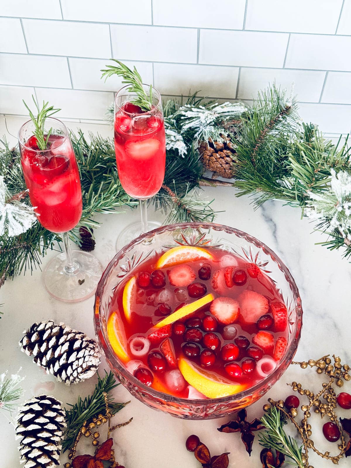 Cranberry and champagne punch with fruit Christmas decor.