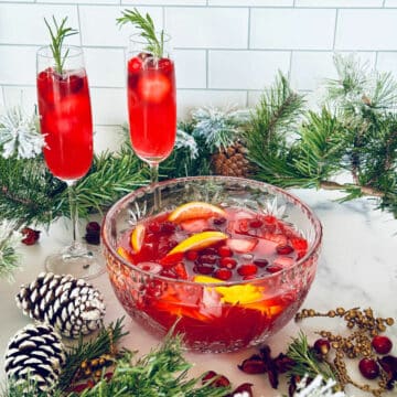 Cranberry and champagne punch with fruit Christmas decor.
