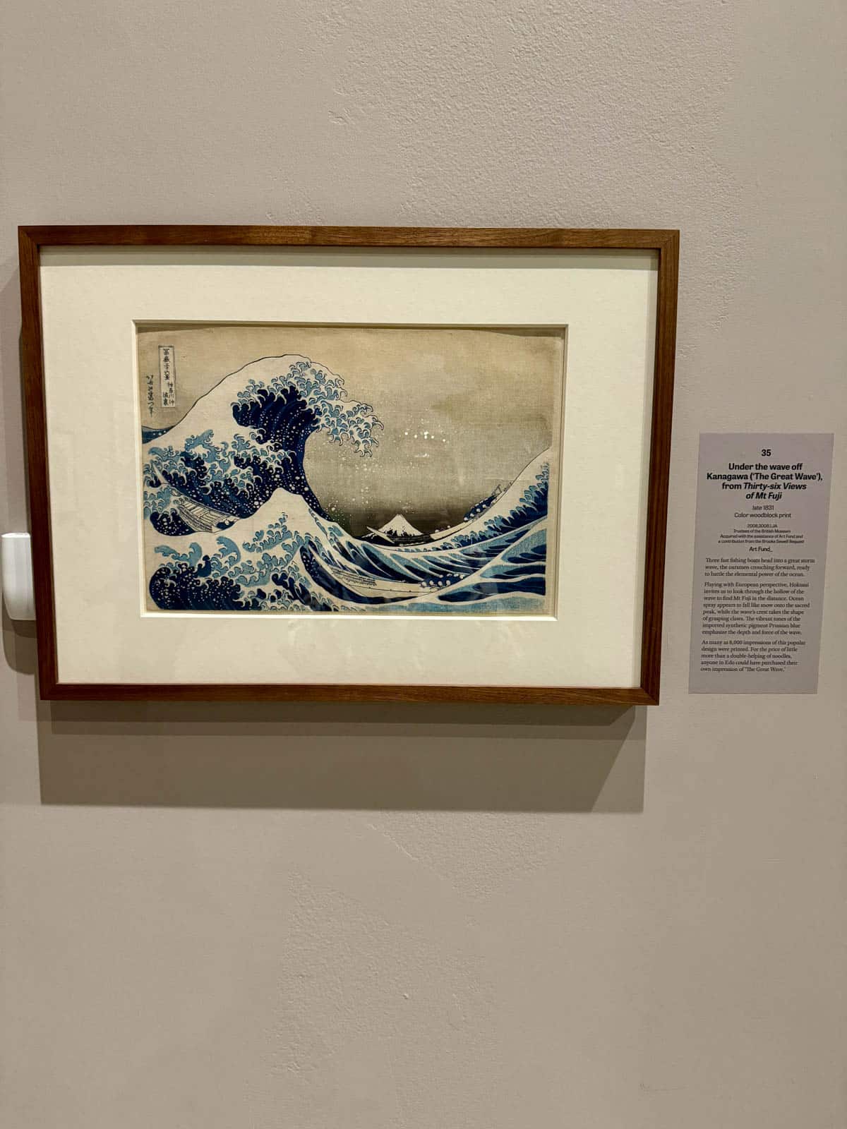 Photograph of art with a wave at museum.