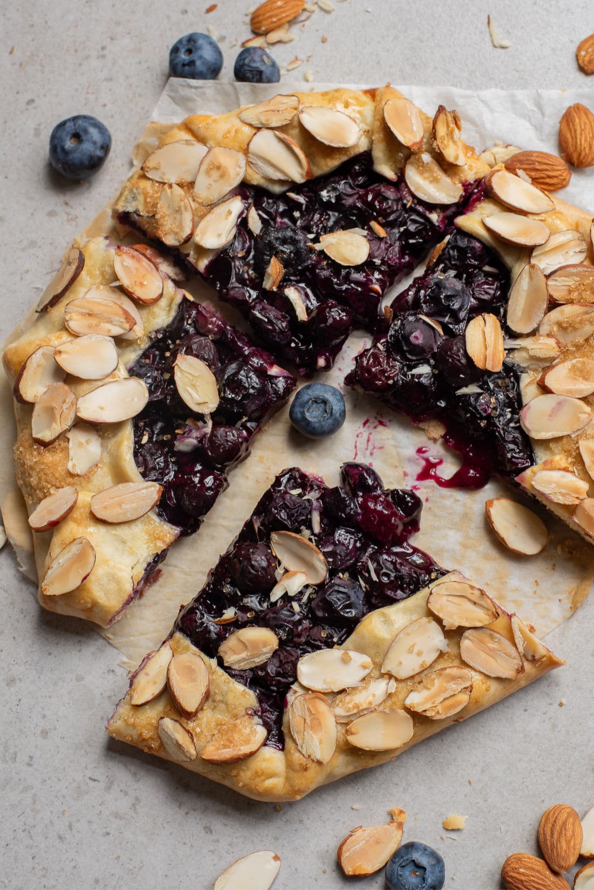 Baked Blueberry Galette cut into four pieces with one pulled away.