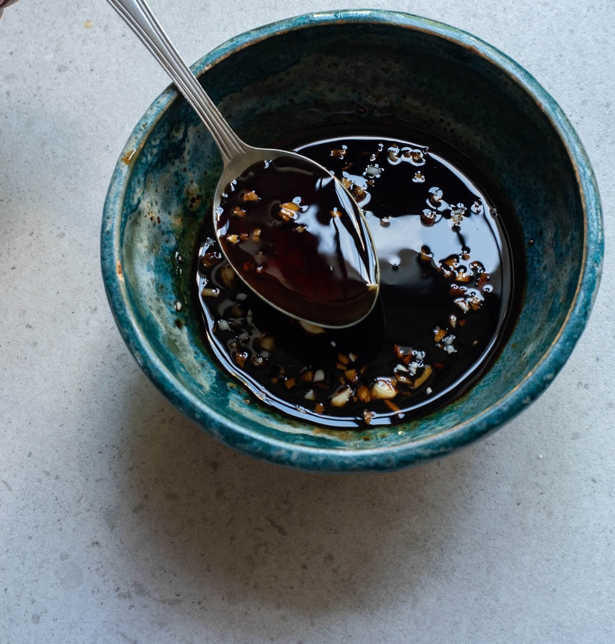 Soy based sauce in blue bowl.