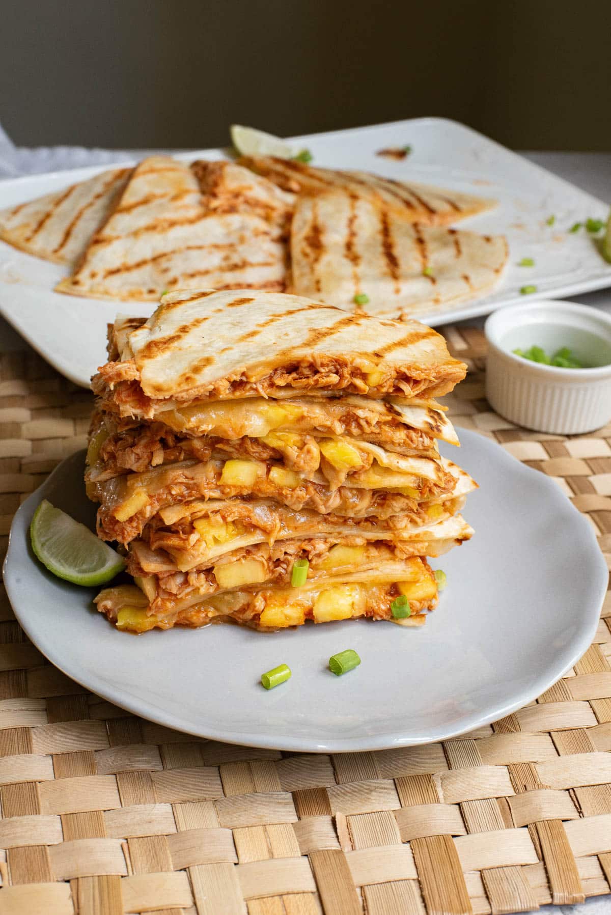 Chicken Quesadillas stacked on a white plate.
