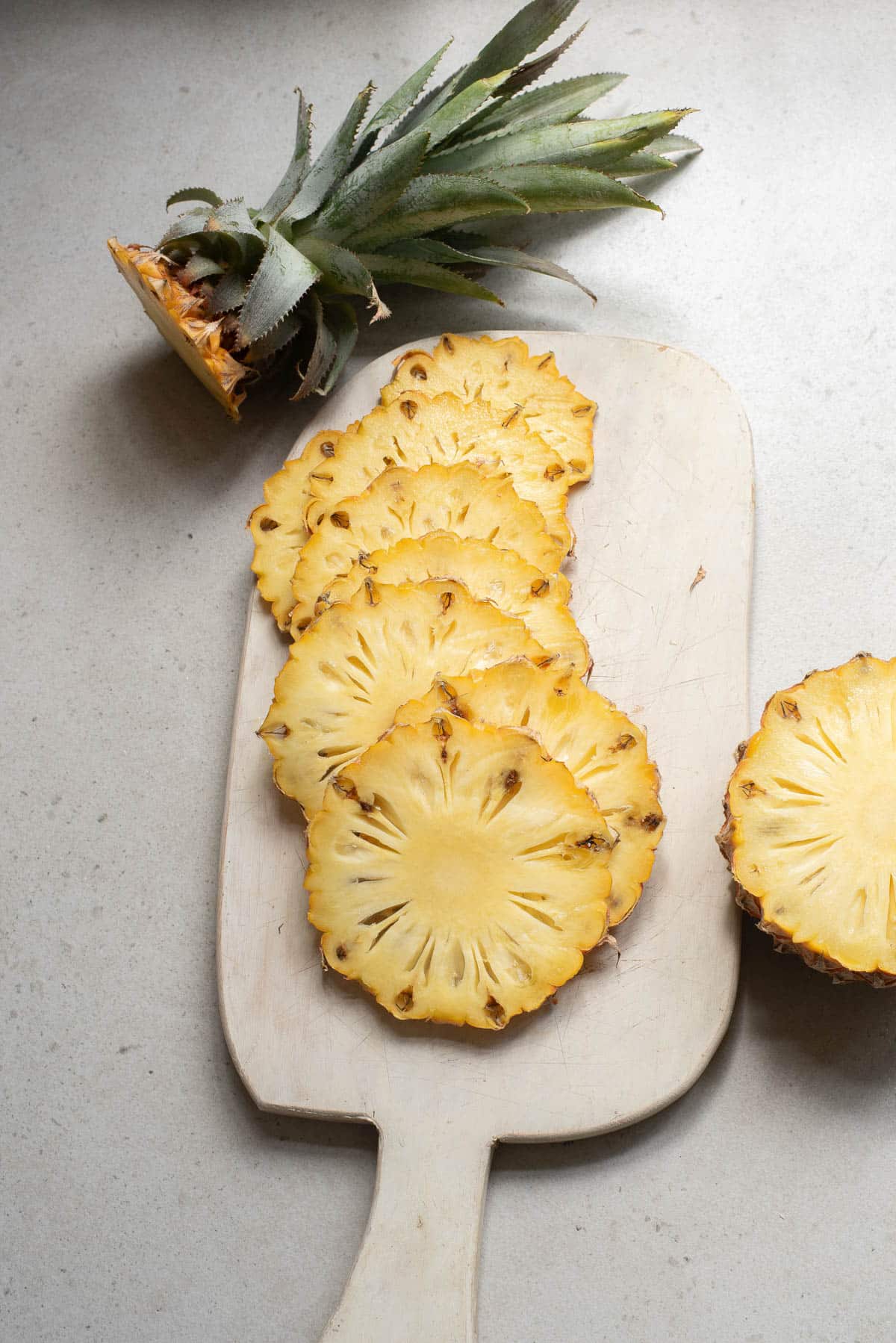 Pineapple slices on a cutting board.