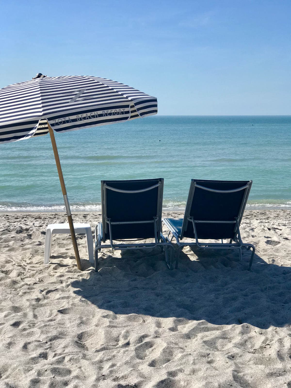 Chairs and an umbrella on the beach.