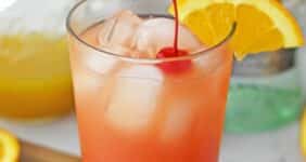 Tropical looking cocktail with an orange slice and cherry.