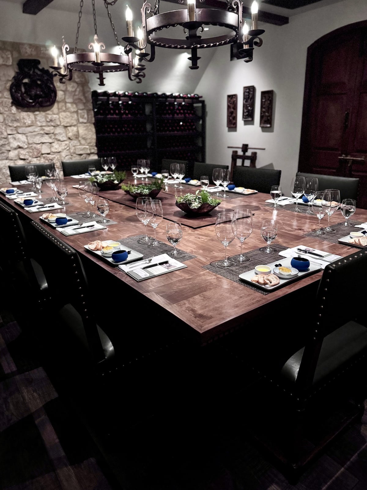 Large table set with food pairings and wine glasses.