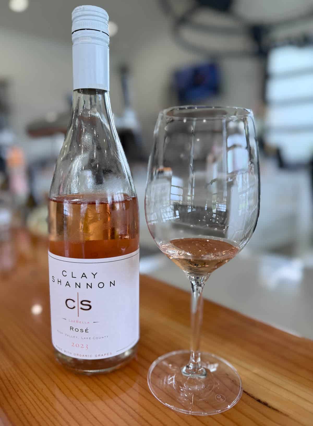 Bottle of rosé wine with glass with small tasting.