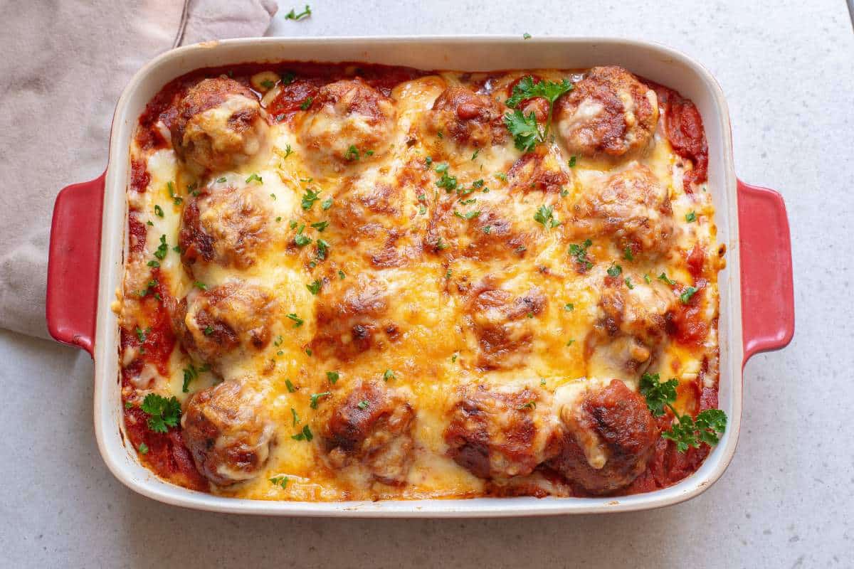 Meatballs in marinara and cheese baked in a casserole dish.