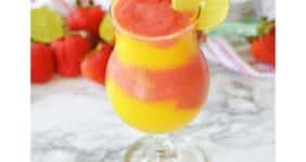 Frozen strawberry and mango daiquiri in a tall glass.