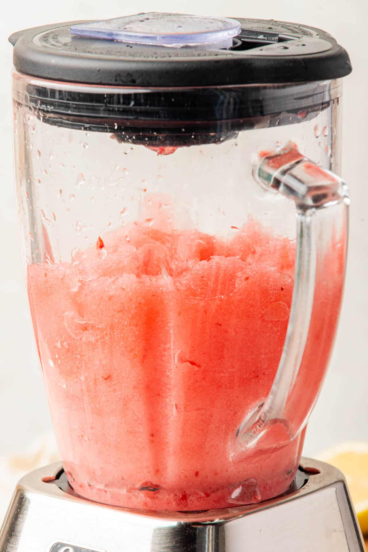 Frozen raspberry mixture in a blender.