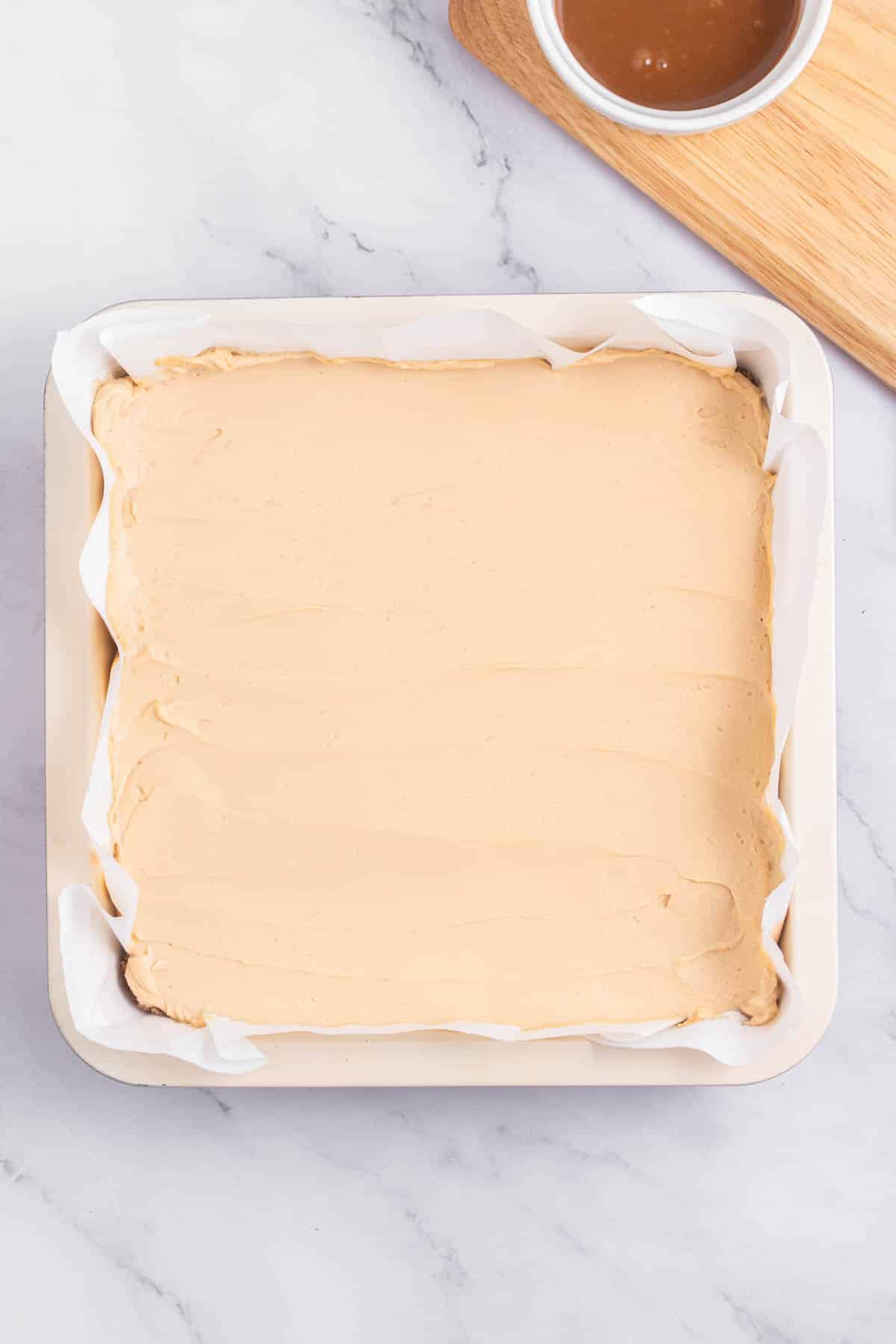 Cheesecake batter in a square pan.