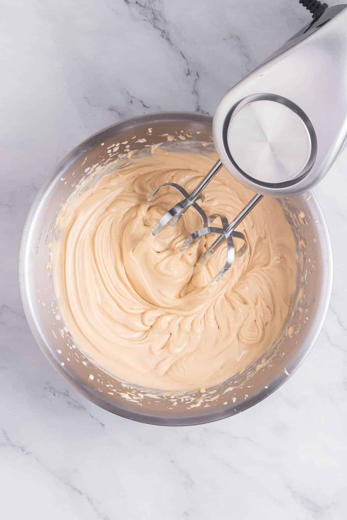 Cheesecake mixture in a stainless bowl.