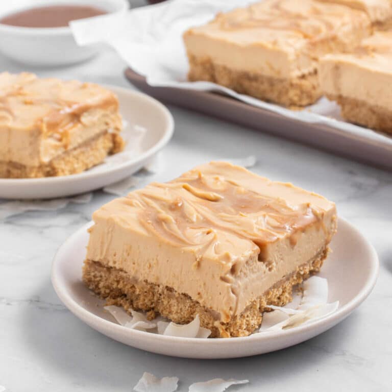 Dulce de leche cheesecake bar on a white plate.