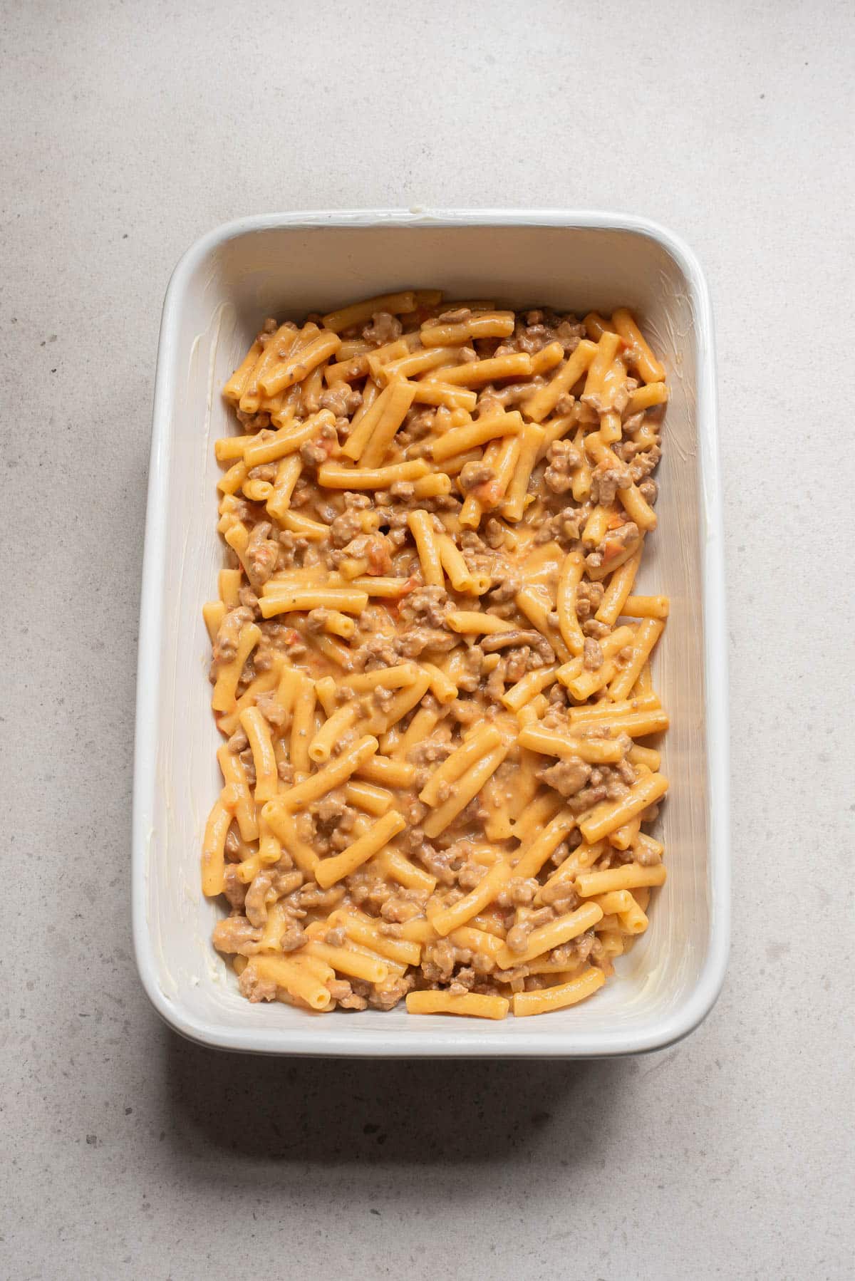 Casserole dish with pasta, tomato sauce, and cheese.