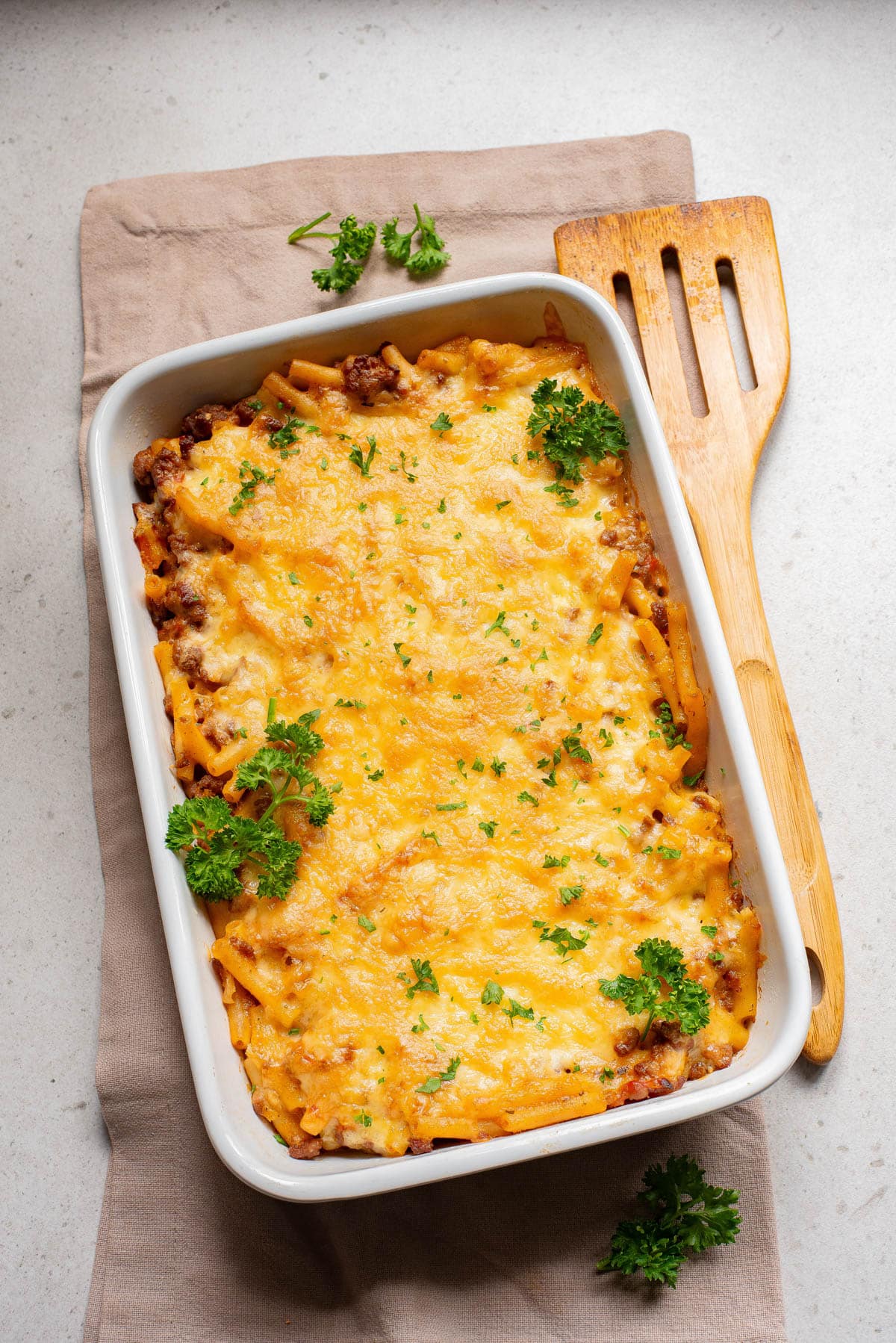 Baking dish with pasta topped with cheese.