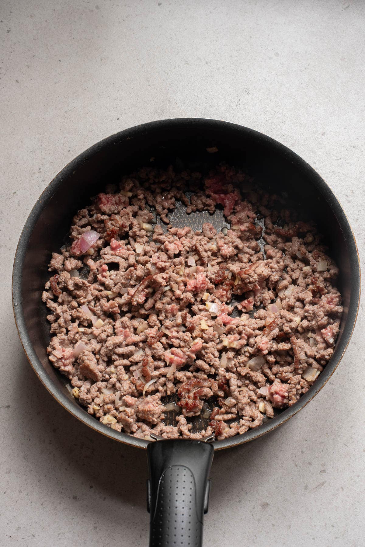 Pan with ground beef, onion, and garlic.