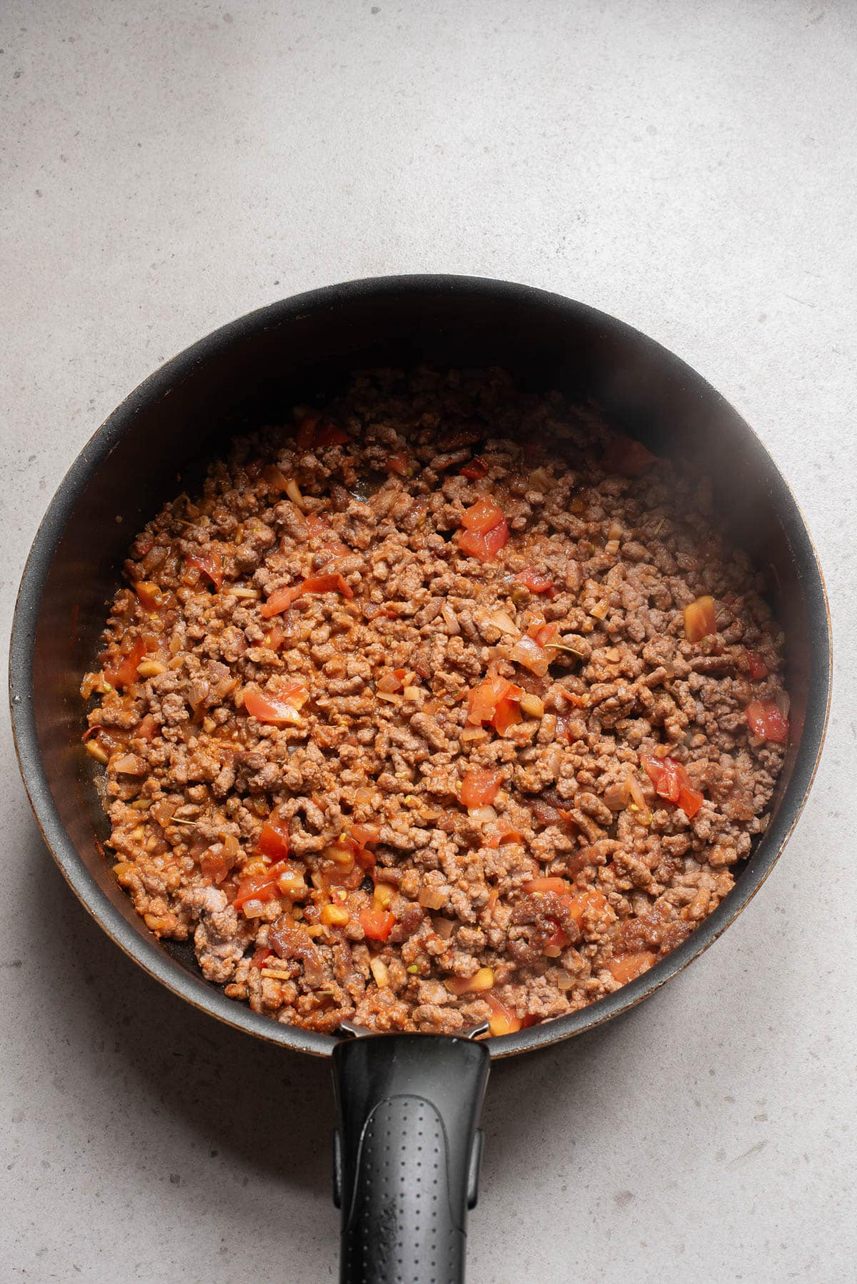 Ground beef with seasoned tomato in a pot.