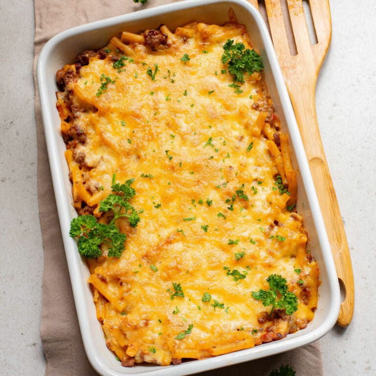 Baked ziti topped with cheese and fresh parsley.