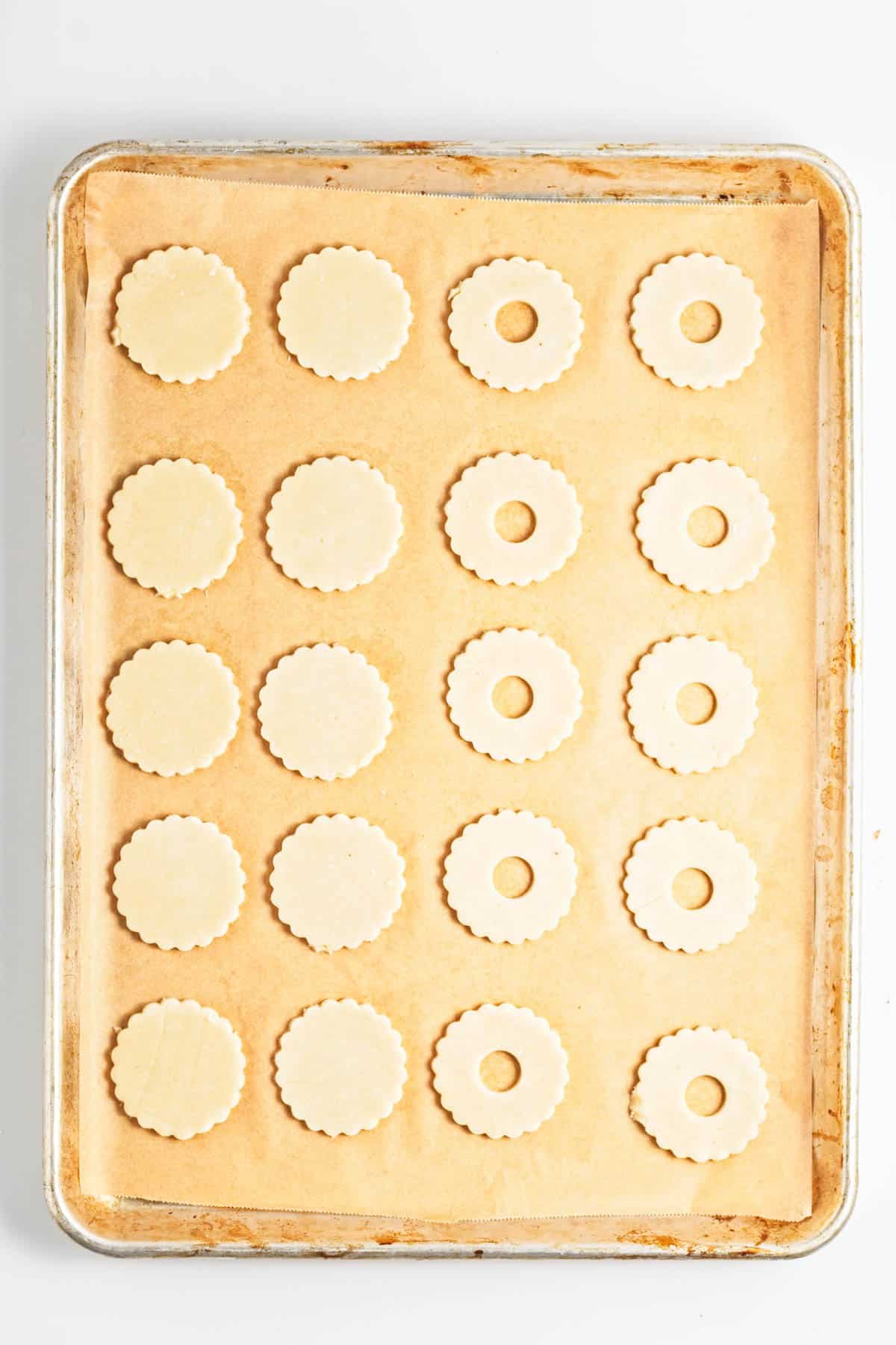 Unbaked cookies on a cookie sheet.