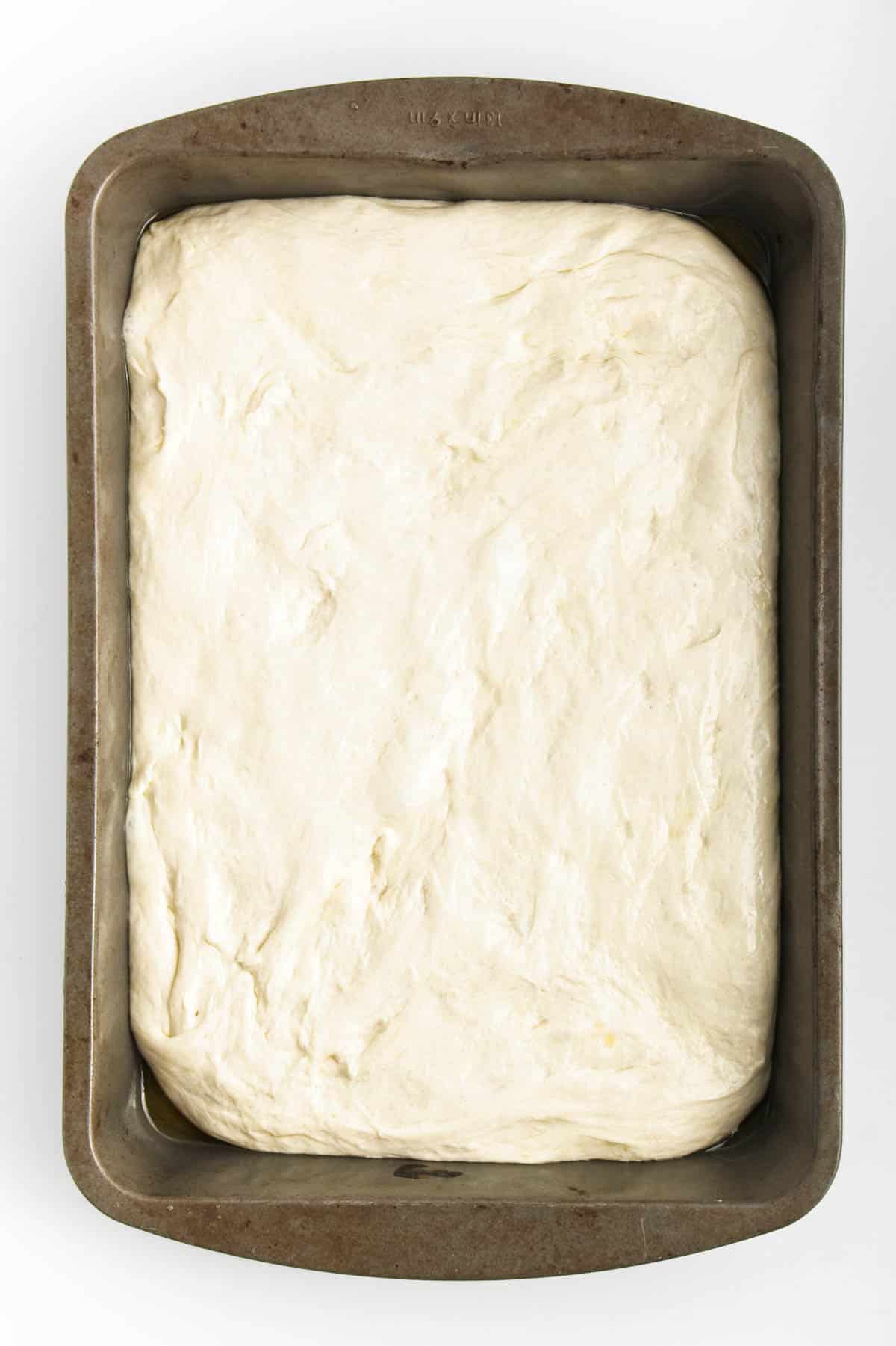 Dough spread in a baking pan.