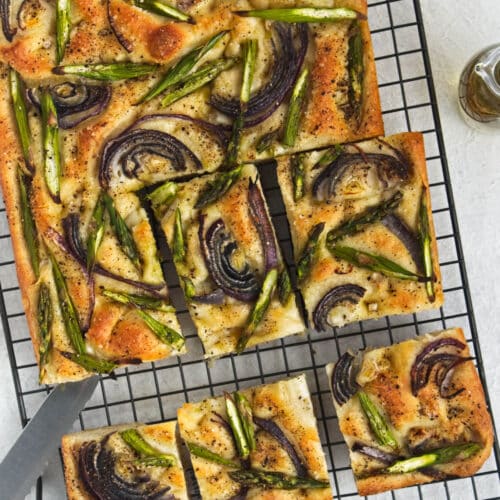 Focaccia on a cooling rack cut into squares.