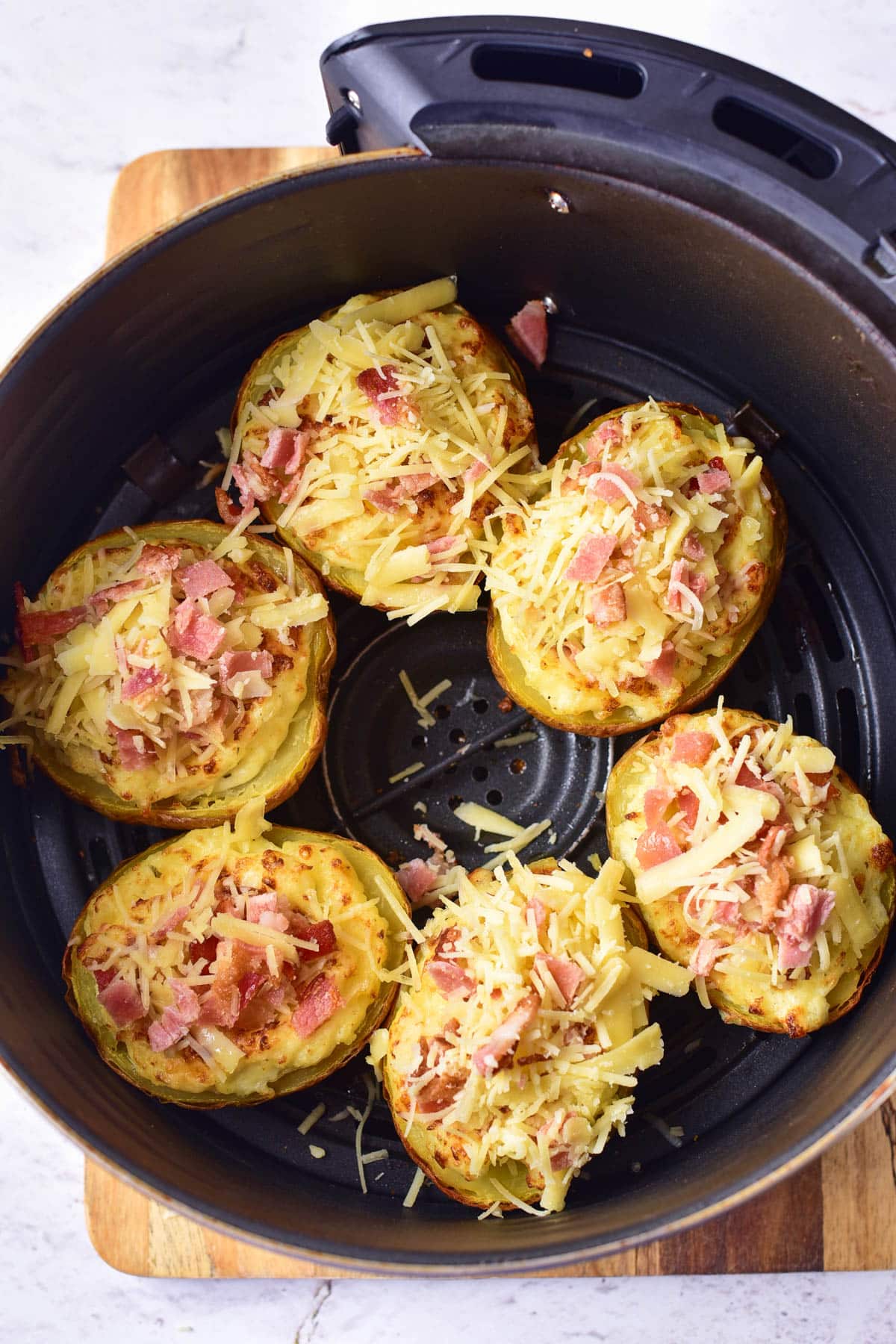 Stuffed potatoes with more cheese in an air fryer.