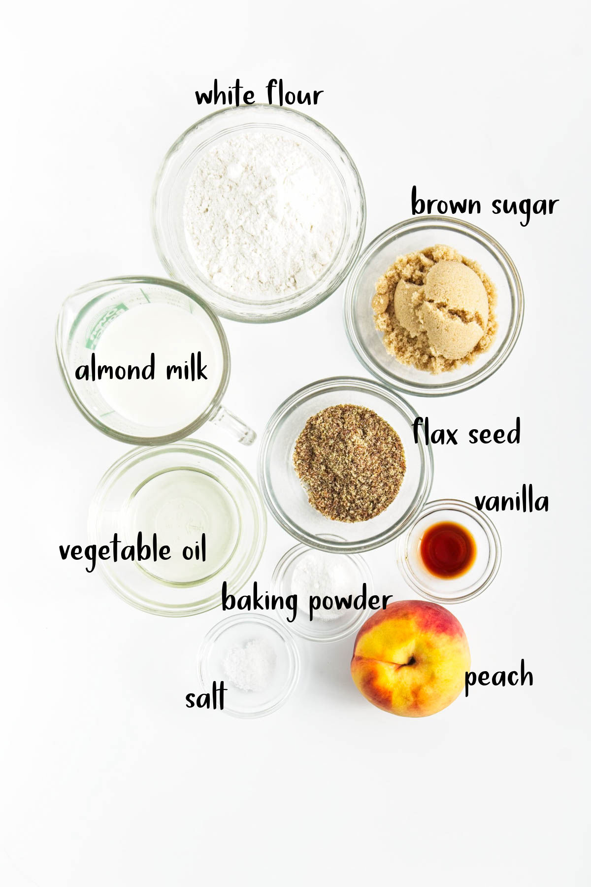 Ingredients for peach muffins on white counter.