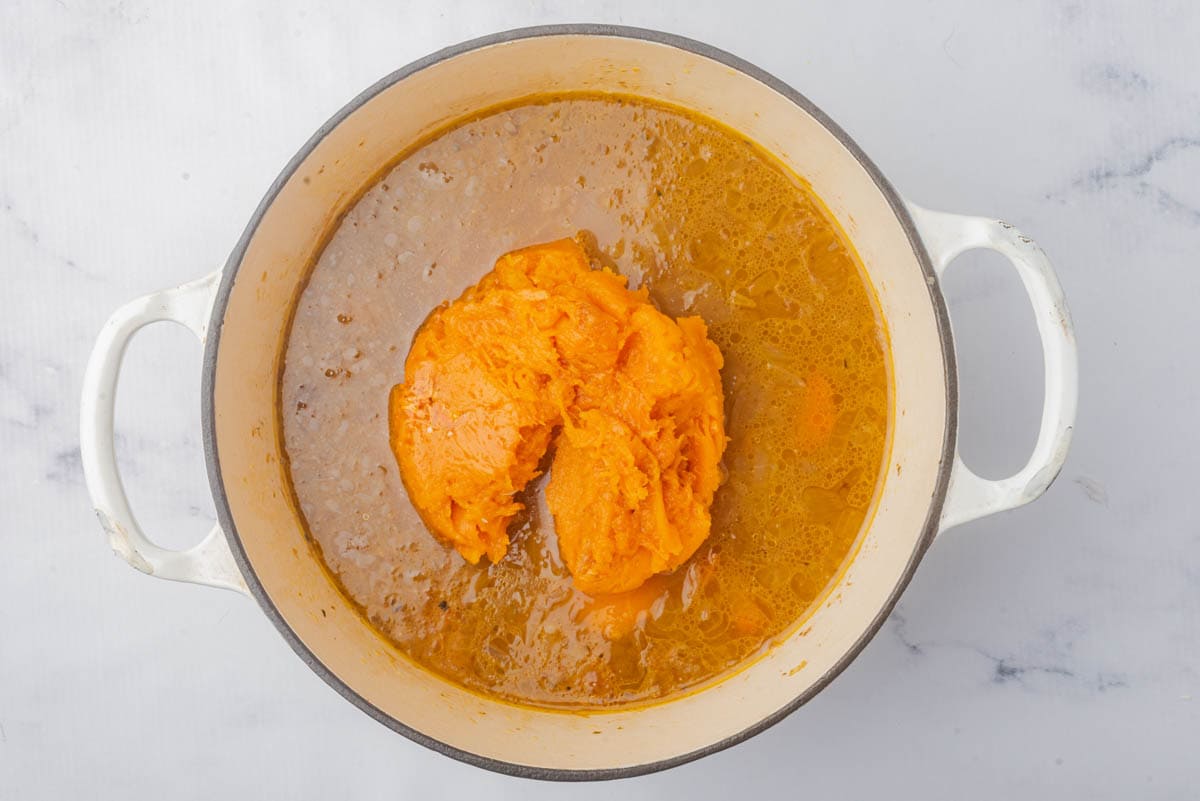 Soup with mound of pumpkin in center.