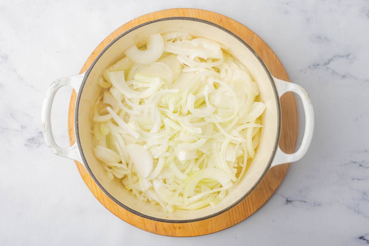 Raw onions in a pot.