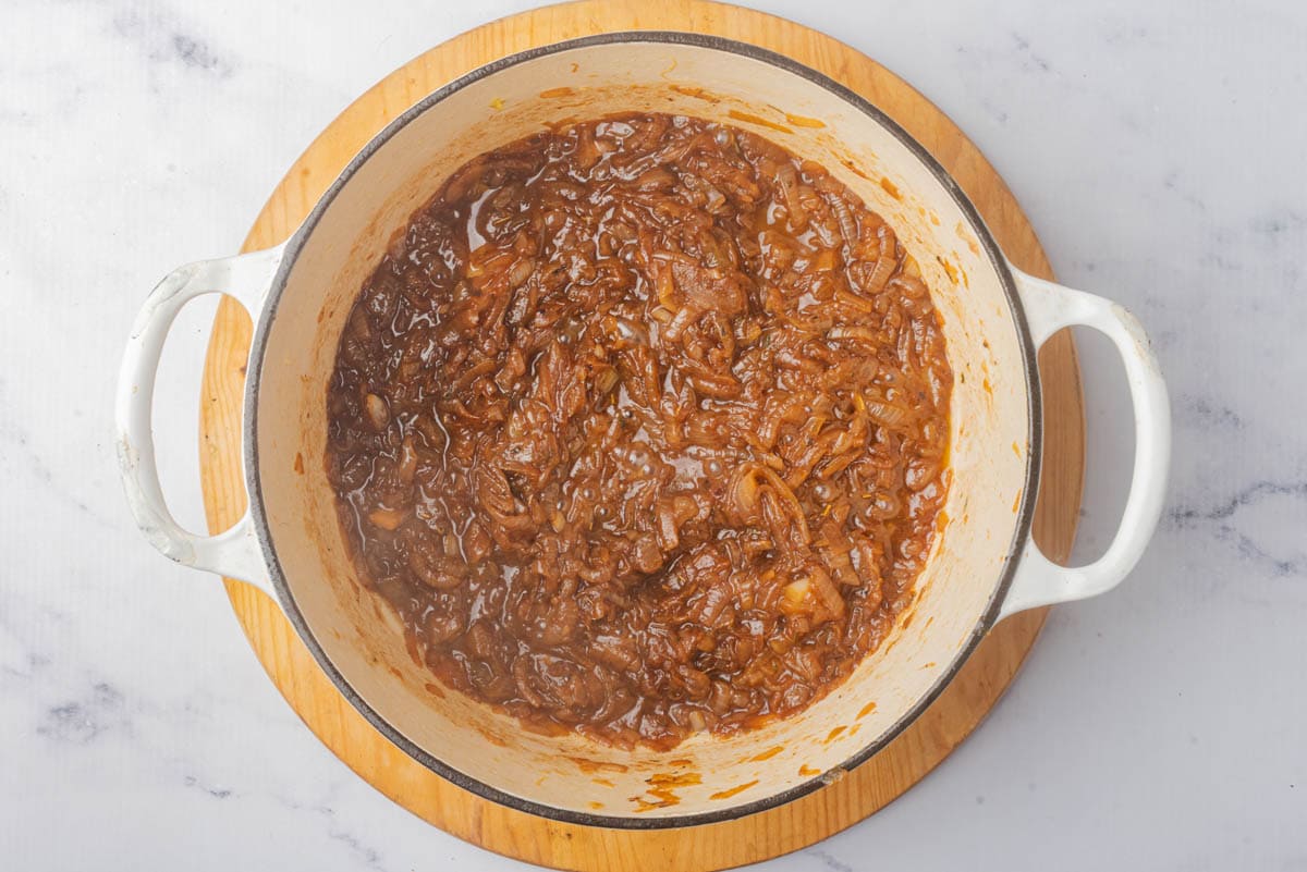 Caramelized onions in a pot with spices.