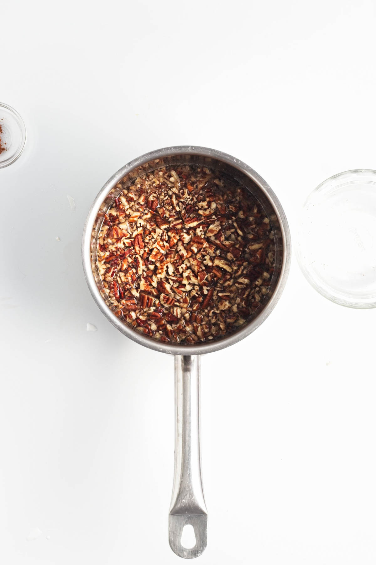 Pecan pieces in syrup in small pan.