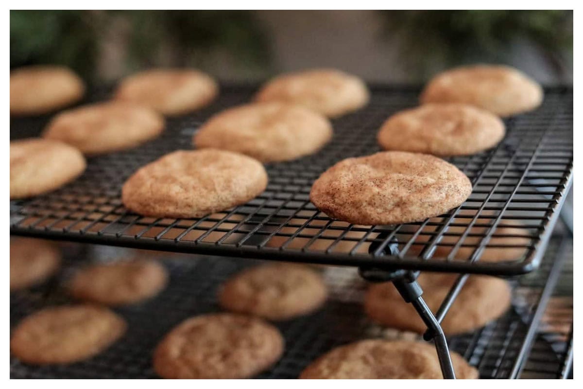 Snickerdoodle cookies on a baking rack.