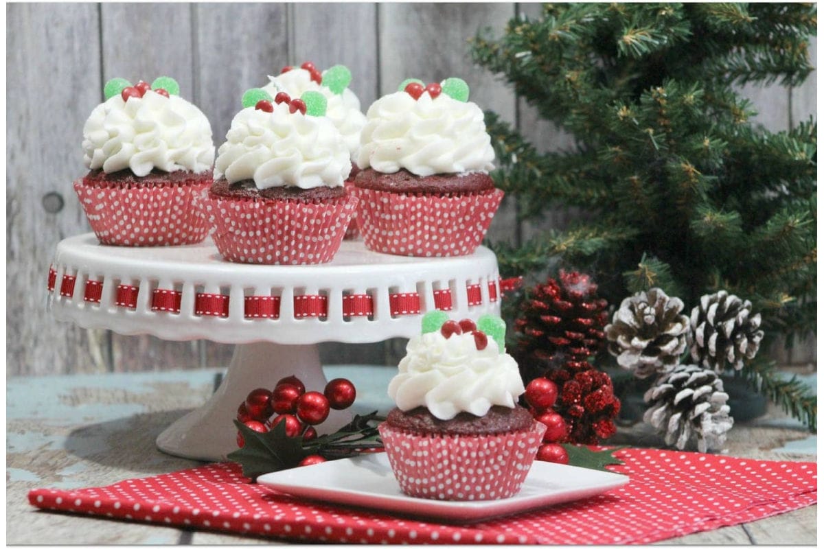 Chocolate cupcakes with peppermint frosting and festive sprinkles on top.