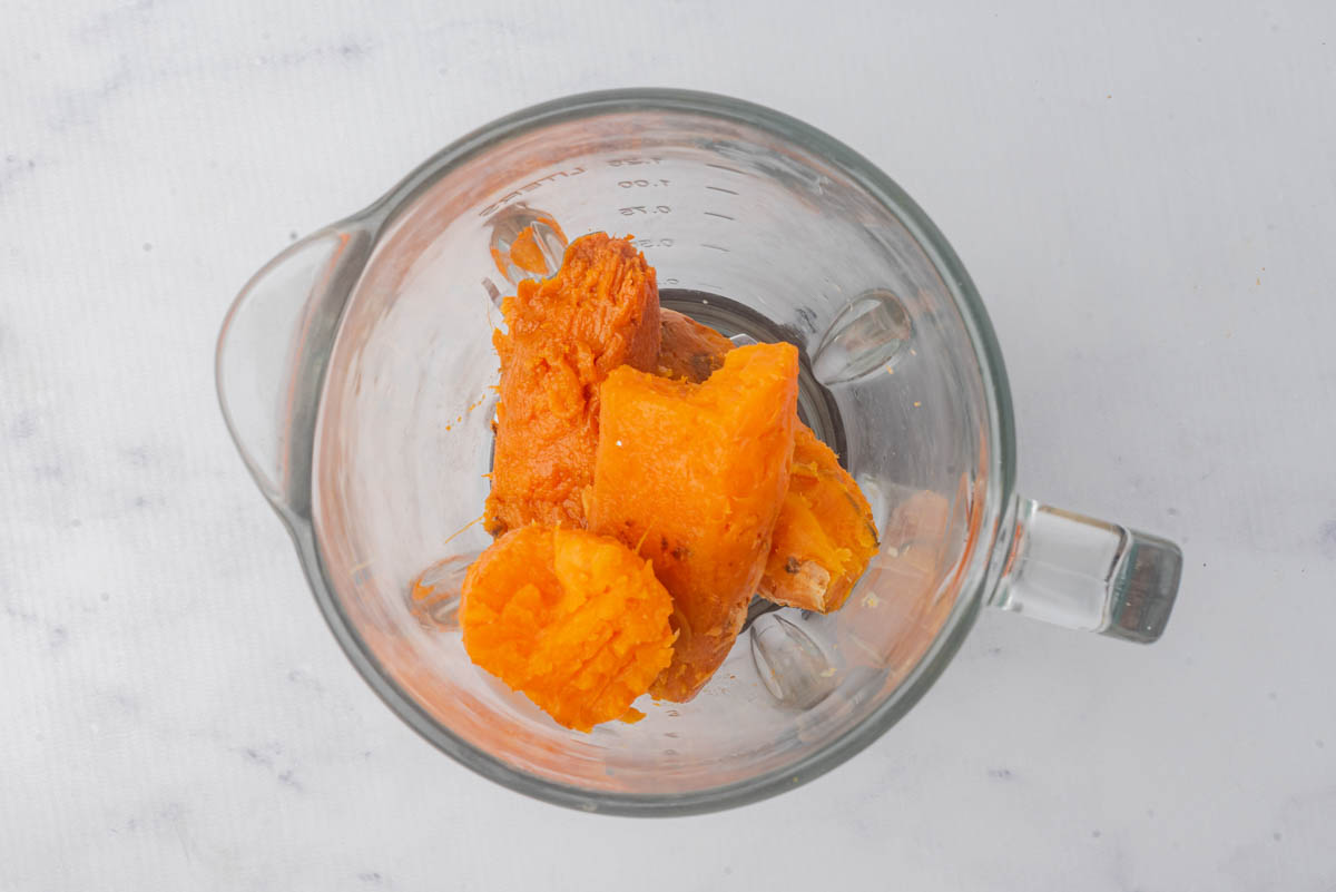 Sweet potatoes in a glass measuring cup.