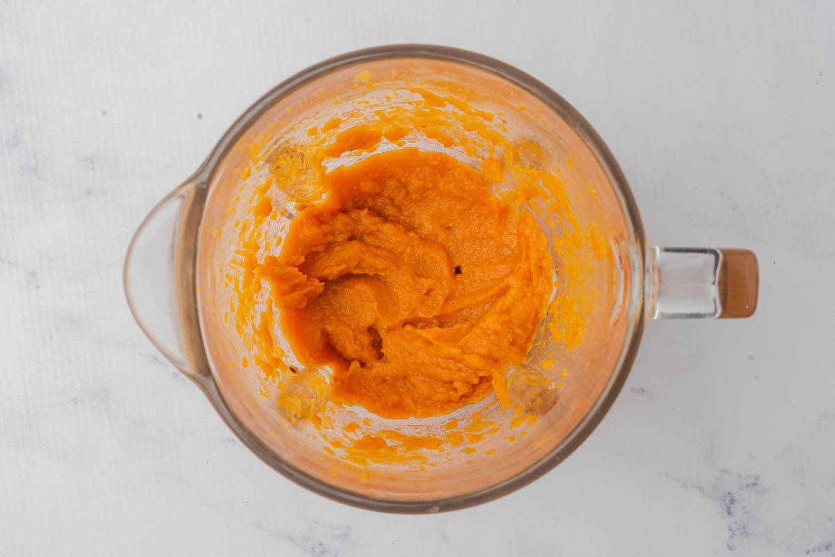 Whipped sweet potatoes in a glass measuring cup.