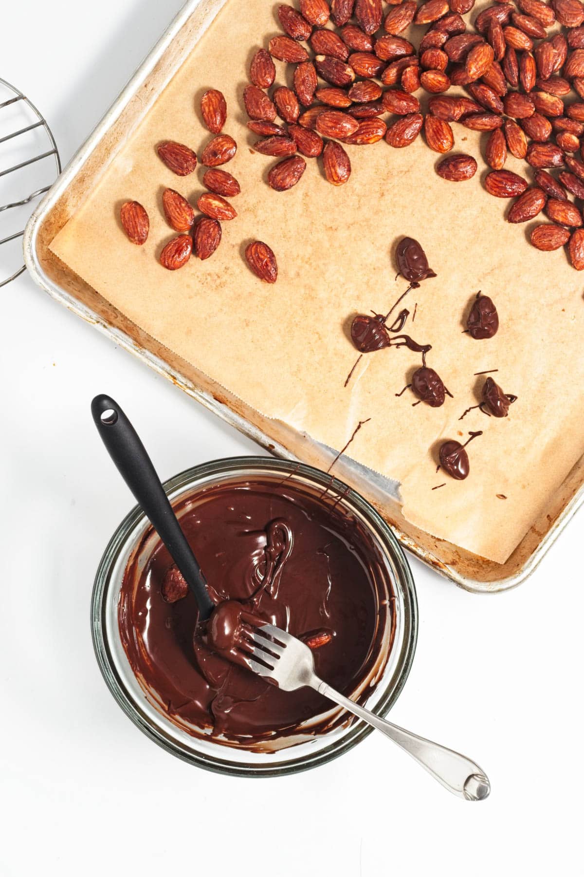 Placing almonds in melted chocolate.