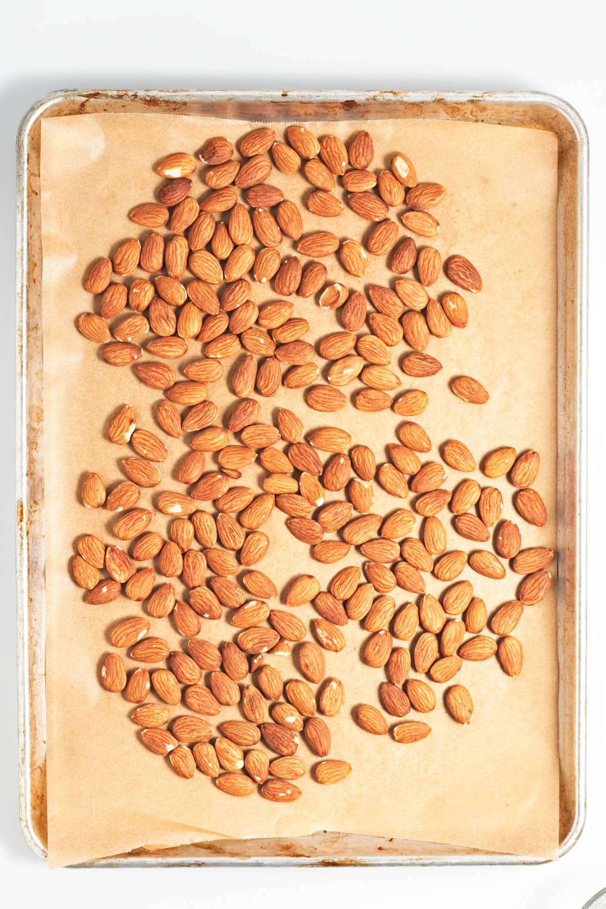 Almonds spread on a baking sheet.