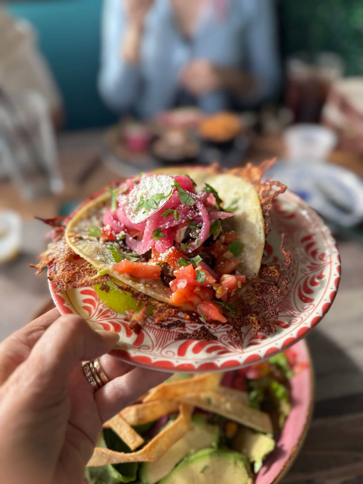 Mexican tacos on a decorated plate.