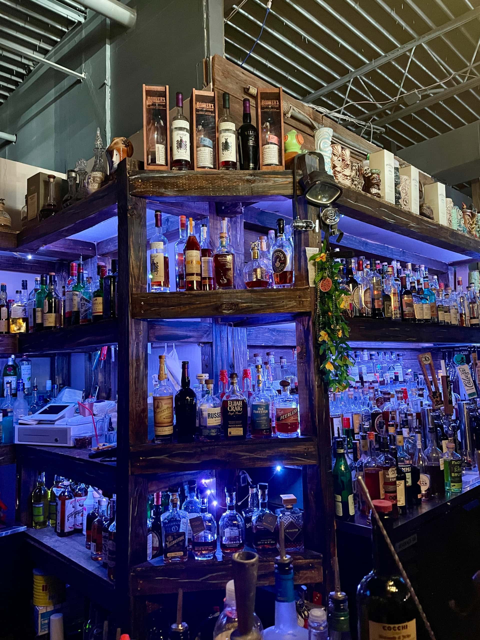 Shelves with bottles of liquor in dark lighting.