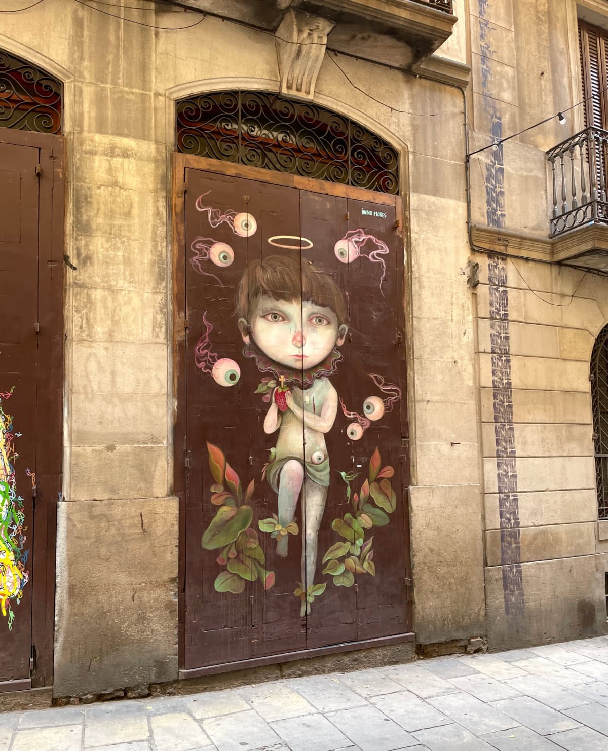 Street art of a comical girl walking through leaves.