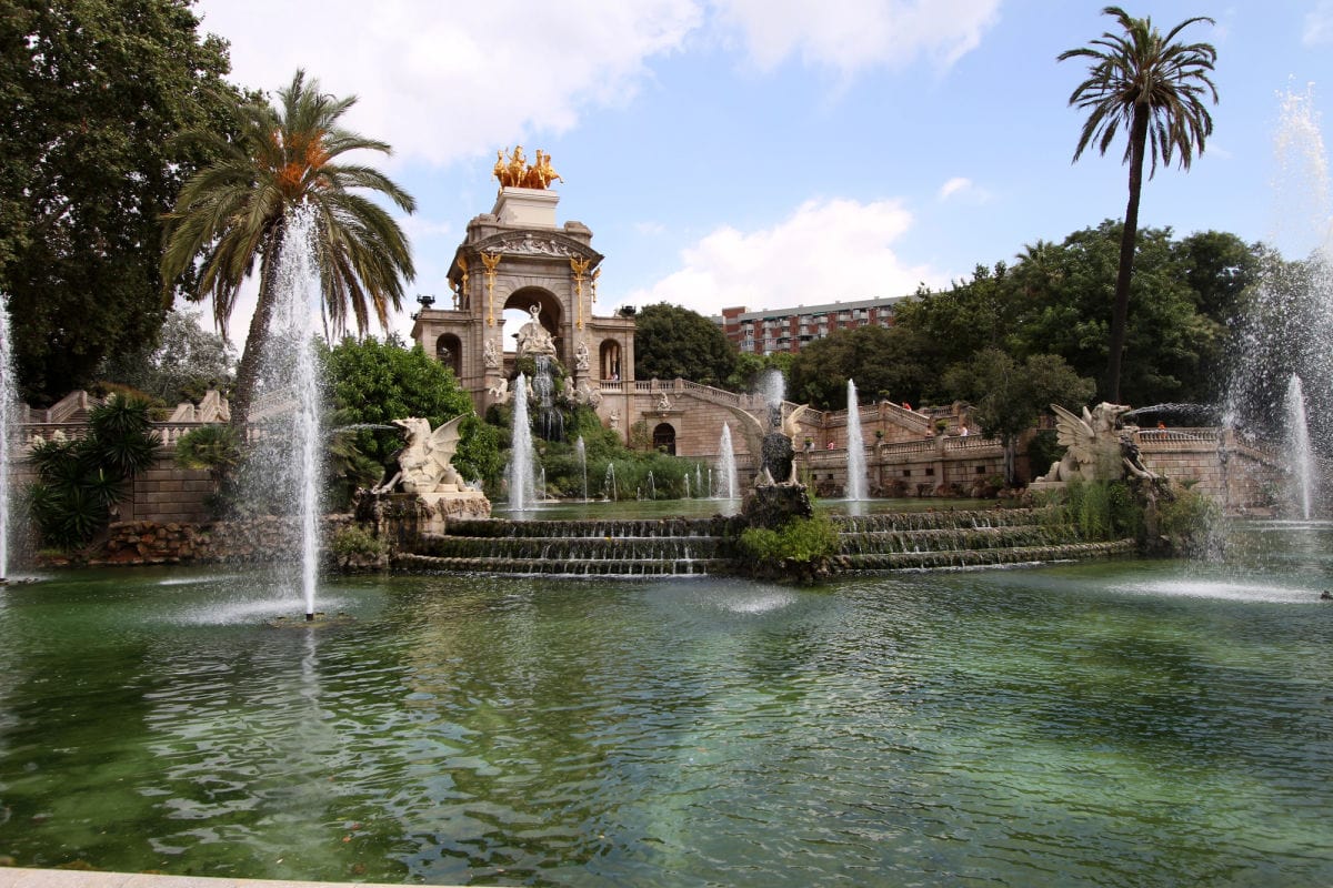 Gardens and fountain in park.